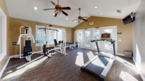 Pet Friendly Apartments in Ontario CA - Rancho Vista - Resident Gym With Two Ceiling Fans, a Treadmill, and Other Exercise Machines
