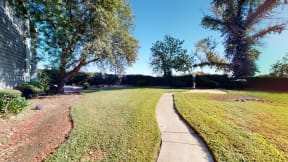 Two Bedroom Apartments in Ontario CA - Rancho Vista - Community Landscape With Lush Grass, Paved Walkway, and Pet Pick Up Station
