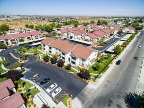 Apartments for Rent High Desert CA - Exterior View of Riverton of the High Desert's Building Showing Expansive Community and Green Landscaping