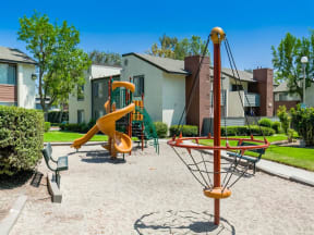 Pet Friendly Apartments in Ontario CA - Avante - Outdoor Playground with Sand Box and a Couple of Benches