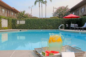 Apartments in West Covina, CA - Tuscany Villas Sparkling Swimming Pool Surrounded By Lush Landscaping and Lounge Seating in the Center of the Courtyard