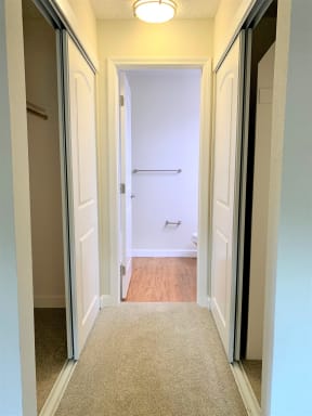 short hallway closet walkway and entrance to bathroom