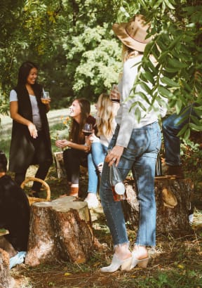 a group of people standing around a tree stump