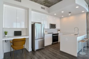 a kitchen with stainless steel appliances and desk