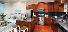 Kitchen with wood cabinets and stainless steel appliances | Element apartments