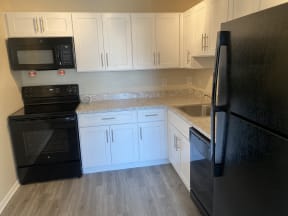 Kitchen with black appliance package  | The Brittany