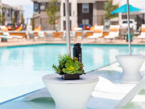 side table and recliner by pool