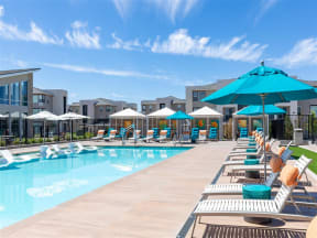 pool, lounge chairs and umbrellas