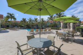 Poolside tables and umbrellas  | Monterra at Bonita Springs