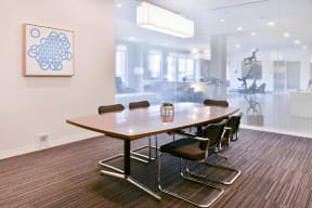 Private business room with conference table and a frosted glass wall.