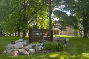 Exterior of Boulder Court Apartments and the large building sign.