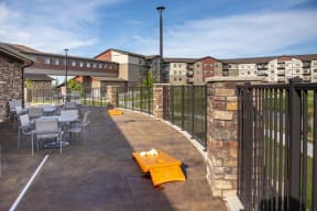 Outdoor Patio with Tables and Cornhole