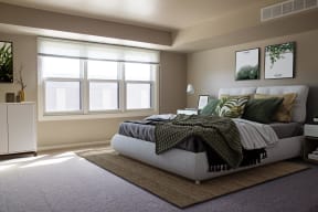 Spacious bedroom with three large windows brightening the space.