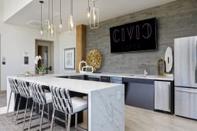 Full community kitchen with bar, seating and large television
