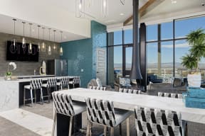 Sky lounge kitchen area, with full kitchen and bar, high seating, and fireplace connected to the ceiling
