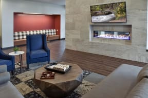 Clubroom fireplace lounge with cozy seating nooks.