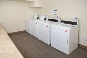 On site coinless laundry room with 2 washers and 2 dryers.
