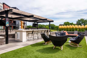 Outdoor entertaining space with a pergola, dining area, and comfortable seating.
