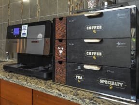 Coffee bar featuring a modern barista-style machine perfect for grabbing a coffee on the go.