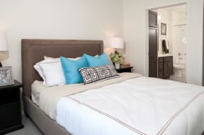 Furnished bedroom with queen bed and attached private bathroom