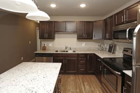 Full Kitchen with Island and Dark Wood Cabinets