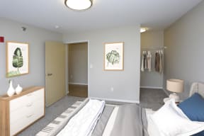 Spacious bedroom with open closet in the right corner.