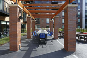 Outdoor courtyard complete with a variety of tables and a pergola.
