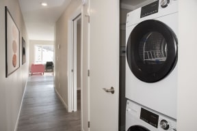 Stacked in unit washer and dryer included in studio units.