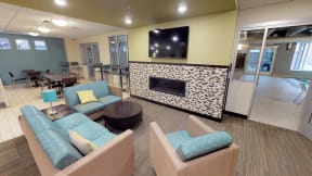 Community Room with Lounge Charis Fireplace and TV
