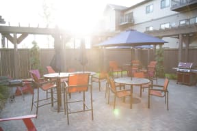 Outdoor Community Patio with Tables and Grill