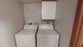 In Unit Washer Dryer with mounted cabinet above.
