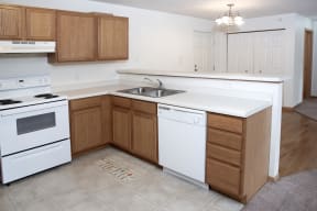 Full Kitchen with Wood Cabinets, White Appliances and Counter Tops