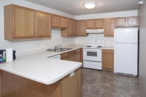 Full Kitchen with Attached Island, Wood Cabinets and White Appliances