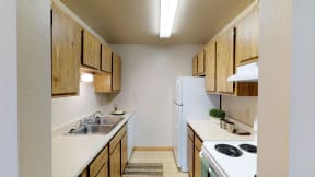 Full Kitchen with Wood Cabinets, White Appliances and Laminate Countertops