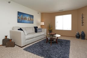 Cozy carpeted living room off the separate dining space complete with a window giving ample natural light.