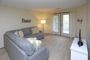 Comfortable and spacious living room with natural light from the doors leading out to your patio or balcony.