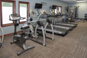 Fitness center equipped with treadmills, strength training machines, bikes, and more.