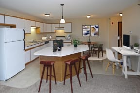 An open kitchen complete with an island for entertaining and room to spare for a work from home desk area.