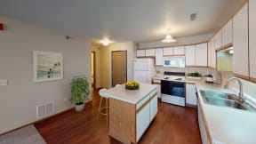 Side view of a spacious kitchen with white cabinetry and ample amounts of storage space.