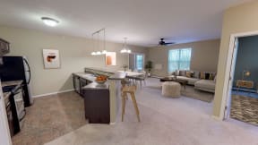 Full Kitchen with Breakfast Bar and Open Furnished Living Room with Windows
