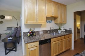Kitchen with light wood cabinets, granite counter top