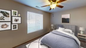 Furnished bedroom with queen bed, ceiling fan and large window for natural light