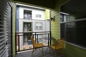 Private patio access from your apartment with black iron railing.