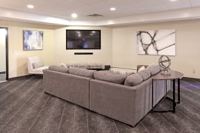 Community room with sectional couch and large TV