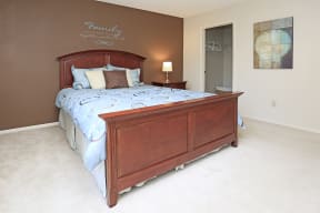 Bedroom with bed and nightstand, walk in closet