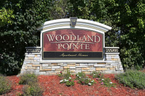 Woodland Pointe Sign with surrounding greenery