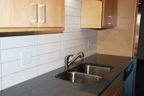 Kitchen with tile backsplash and granite countertops