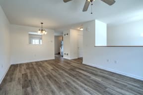 living room with hardwood floors and ceiling fan natural light