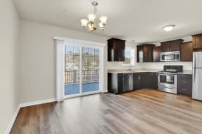 mocha cabinets with granite hardwood floors kitchen and dining with doors leading to deck