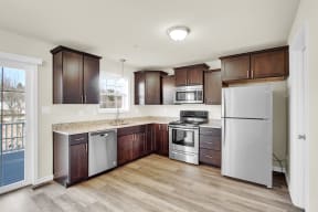 walnut cabinets with granite countertops and stainless steel appliances hardwood floors kitchen  at Franklin Square Apartments/Townhomes, New Freedom